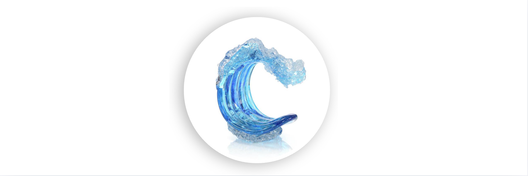 Hand-blown glass sculpture of an ocean wave in vibrant blue hues, displayed on a white background