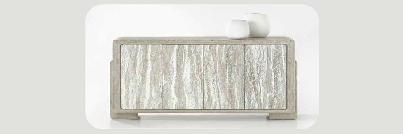 Contemporary sideboard with a textured, stone-like front in neutral tones. The rectangular cabinet features a minimalist design and is topped with two small decorative white vases, set against a clean, white background.     