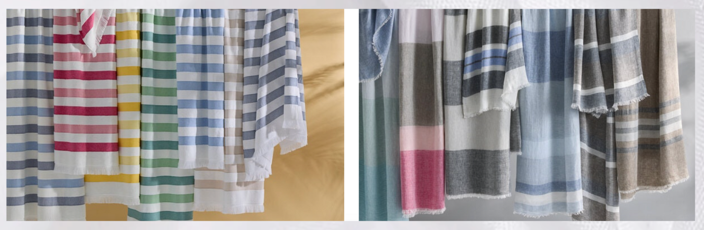 Oversized striped luxury beach towel draped over teak chaise lounge – Marisol Gullo Interiors  White and sand-toned beach towels stacked beside a private pool  Plush tropical-pattern towel spread on beach with woven tote and sunglasses