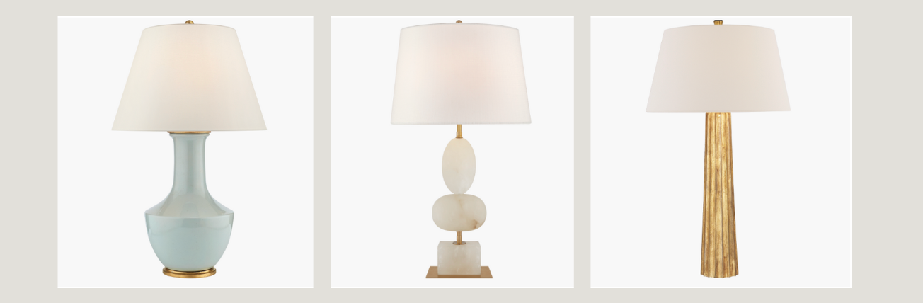 A set of three cordless table lamps, each with a unique base design: one with a smooth blue ceramic base, one with stacked white spheres, and one with a tall, textured gold base. All feature white fabric lampshades and a clean, modern aesthetic.