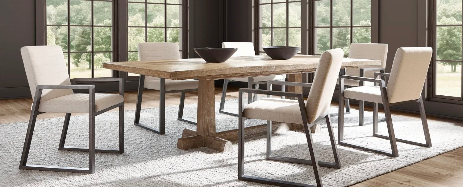 Modern dining room with a wooden rectangular table, six upholstered chairs with black metal frames, and a contemporary chandelier, surrounded by large windows