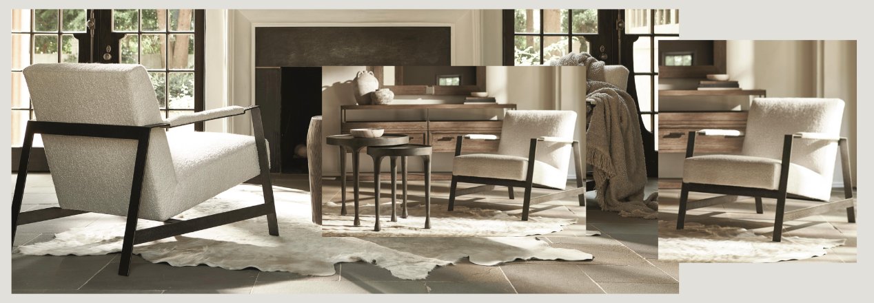 Elegant living room featuring modern armchairs with light upholstery and dark wooden frames, arranged around a round dining table near a fireplace. Large windows let in natural light, and a soft, white area rug adds warmth to the neutral-toned space